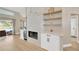 Bright living room featuring a stylish fireplace, built-in shelving, and sliding glass doors at 4617 Basswood St, Land O Lakes, FL 34639