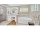 Luxury bathroom features soaking tub, frameless glass shower, and modern vanity at 4617 Basswood St, Land O Lakes, FL 34639