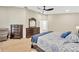 Bright main bedroom with ceiling fan, hardwood floors, and large dresser at 4617 Basswood St, Land O Lakes, FL 34639