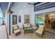 Inviting covered patio with comfortable seating, ceiling fan and access to the pool at 4617 Basswood St, Land O Lakes, FL 34639