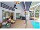 Inviting covered patio with comfortable seating, ceiling fan and a grill, perfect for outdoor entertaining at 4617 Basswood St, Land O Lakes, FL 34639