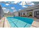 Gorgeous pool area with an enclosed patio and views of the neighborhood at 4617 Basswood St, Land O Lakes, FL 34639