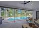 Inviting pool area with comfortable seating, ceiling fan and views of the community at 4617 Basswood St, Land O Lakes, FL 34639