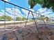 Community swings with a playground view offer residents a place for recreation and enjoyment at 4617 Basswood St, Land O Lakes, FL 34639