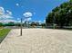 Community volleyball court with lush greenery, providing an excellent recreational area at 4617 Basswood St, Land O Lakes, FL 34639