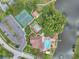 Aerial view of the Community featuring a pool, tennis courts, shuffleboard, and clubhouse at 4712 Coachmen Rd, New Port Richey, FL 34655