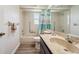 Bathroom with tile flooring, shower-tub combo, window, and vanity with a large mirror at 4712 Coachmen Rd, New Port Richey, FL 34655