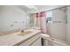 Bathroom with tile flooring, shower, window, and vanity with a large mirror at 4712 Coachmen Rd, New Port Richey, FL 34655