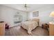 Cozy bedroom with a ceiling fan, bright window, and neutral decor, creating a serene atmosphere at 4712 Coachmen Rd, New Port Richey, FL 34655