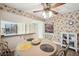 Cozy dining area with wallpaper, a ceiling fan, and access to the kitchen at 4712 Coachmen Rd, New Port Richey, FL 34655