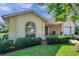 Charming single-story home with a well-manicured lawn, arched window, and a cozy front porch at 4712 Coachmen Rd, New Port Richey, FL 34655