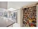 Well-stocked pantry with wire shelving in this white kitchen that has stainless steel appliances and tile flooring at 4712 Coachmen Rd, New Port Richey, FL 34655