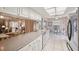Open kitchen showcasing long countertops, white cabinetry, and views to the adjacent breakfast nook at 4712 Coachmen Rd, New Port Richey, FL 34655