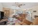 Spacious living room area with a ceiling fan, and views into the dining area at 4712 Coachmen Rd, New Port Richey, FL 34655