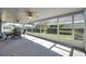 View of screened patio with ceiling fans, furniture, and view of the backyard at 4712 Coachmen Rd, New Port Richey, FL 34655