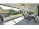View of screened patio with ceiling fans and furniture at 4712 Coachmen Rd, New Port Richey, FL 34655