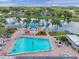 Aerial view of community featuring a large pool, lounge areas, and lake views at 4712 Coachmen Rd, New Port Richey, FL 34655