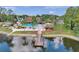 Beautiful community pool and clubhouse overlooking the lake with a fishing pier at 4712 Coachmen Rd, New Port Richey, FL 34655
