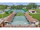 Aerial view of the tennis courts, shuffleboard courts, and clubhouse at 4712 Coachmen Rd, New Port Richey, FL 34655