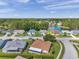 Aerial view of neighborhood featuring a lake and beautifully maintained homes and lawns at 4712 Coachmen Rd, New Port Richey, FL 34655