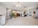 Sunroom with tile floors and walls of glass overlooking outdoor greenery and offering access to home interior at 4712 Coachmen Rd, New Port Richey, FL 34655