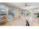 Spacious sunroom with large windows, tile flooring, and access to the backyard, perfect for relaxation at 4712 Coachmen Rd, New Port Richey, FL 34655