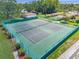 Aerial view of the community tennis courts surrounded by lush landscaping at 4712 Coachmen Rd, New Port Richey, FL 34655