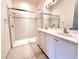 Elegant bathroom with double vanity, glass-enclosed shower, and tiled floors at 4950 Sandy Brook Cir, Wimauma, FL 33598