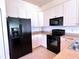 Well-equipped kitchen featuring white cabinetry, stainless steel sink, and modern appliances at 4950 Sandy Brook Cir, Wimauma, FL 33598