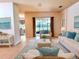 Cozy living room with neutral colors, tile flooring, and sliding glass door access to the outdoors at 4950 Sandy Brook Cir, Wimauma, FL 33598