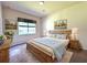 Relaxing main bedroom featuring a comfortable bed, soft lighting, and stylish decor at 4950 Sandy Brook Cir, Wimauma, FL 33598