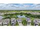 This aerial view captures a charming home nestled in a community with a pond and lush green spaces surrounding it at 5522 Appleton Shore Dr, Apollo Beach, FL 33572