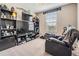 This bedroom is decorated with sports memorabilia and has a black bookcase filled with items, and a gray reclining armchair at 5522 Appleton Shore Dr, Apollo Beach, FL 33572