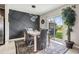 Elegant dining area with a modern light fixture, a decorative wall, and a sliding glass door at 5522 Appleton Shore Dr, Apollo Beach, FL 33572