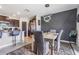 Stylish dining area featuring a modern chandelier, decorative wall, and an open layout with the kitchen at 5522 Appleton Shore Dr, Apollo Beach, FL 33572