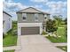 Charming two-story home featuring a two-car garage and a well-manicured lawn, creating a welcoming curb appeal at 5522 Appleton Shore Dr, Apollo Beach, FL 33572