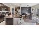 Modern kitchen and dining area featuring dark cabinets, stainless steel appliances, and stylish decor at 5522 Appleton Shore Dr, Apollo Beach, FL 33572