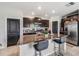 Charming kitchen with granite counters, stainless steel appliances, island, and dark cabinetry at 5522 Appleton Shore Dr, Apollo Beach, FL 33572