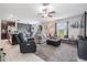 Spacious living room featuring comfortable seating, a ceiling fan, and abundant natural light at 5522 Appleton Shore Dr, Apollo Beach, FL 33572