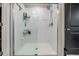 Bathroom with white-tiled shower and glass door at 5522 Appleton Shore Dr, Apollo Beach, FL 33572