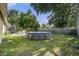 A backyard featuring an above-ground pool, patio furniture, and plenty of lawn space at 5632 62Nd N St, St Petersburg, FL 33709