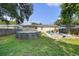 Fenced backyard featuring an above-ground pool and a cozy patio seating area with grill at 5632 62Nd N St, St Petersburg, FL 33709