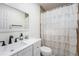Cozy bathroom featuring a large mirror and a shower with a decorative white curtain at 5632 62Nd N St, St Petersburg, FL 33709