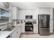 Modern kitchen featuring white cabinets, stainless steel appliances, and marble countertops at 5632 62Nd N St, St Petersburg, FL 33709
