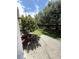 Backyard featuring concrete patio and flower tree and hedge at 5644 Samter Ct, Tampa, FL 33611