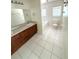 Bathroom featuring tile floor, double vanity, and a combined tub and shower at 5644 Samter Ct, Tampa, FL 33611