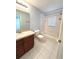 Cozy bathroom featuring a bathtub with white tiles, vanity, and neutral wall paint at 5644 Samter Ct, Tampa, FL 33611