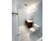 Clean bathroom with a single sink vanity and white tile flooring at 5644 Samter Ct, Tampa, FL 33611