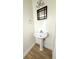 Bathroom featuring tile floor and pedestal sink with mirror and light fixture at 5644 Samter Ct, Tampa, FL 33611