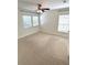 This bedroom features neutral carpet, a ceiling fan and two windows with blinds at 5644 Samter Ct, Tampa, FL 33611